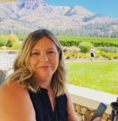 Allison Conrad, travel advisor at Travel Adventures Unlimited, smiling in a professional portrait