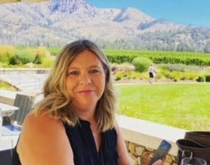 Allison Conrad, travel advisor at Travel Adventures Unlimited, smiling in a professional portrait