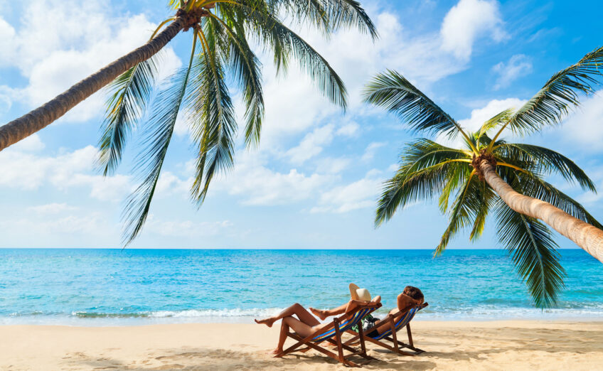 Luxury beach vacation in tropical destination with turquoise water, white sand, and upscale travel amenities