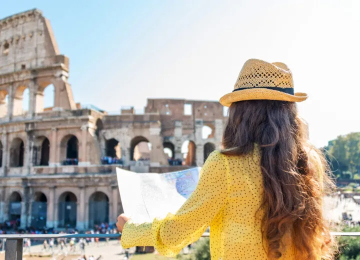 Iconic Colosseum in Rome under clear sky, representing luxury European travel and historic exploration