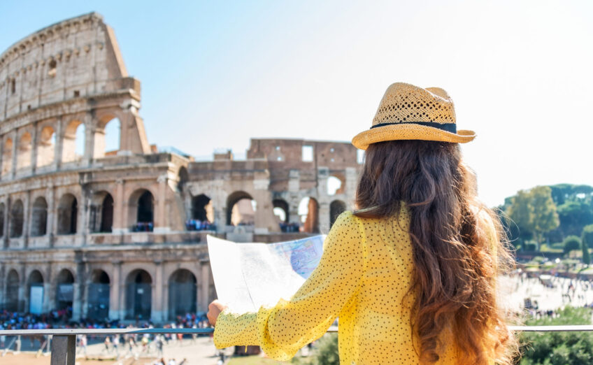 Iconic Colosseum in Rome under clear sky, representing luxury European travel and historic exploration