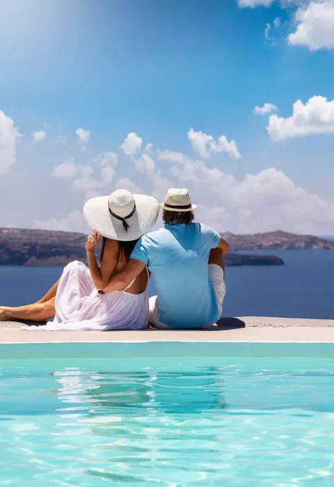 Couple overlooking the ocean from a scenic viewpoint at sunset