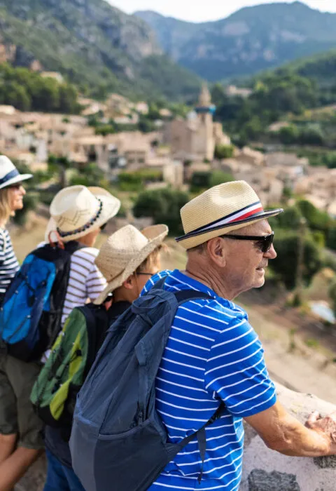 Happy family on a multi-generational travel experience, enjoying a custom-planned hosted group vacation together