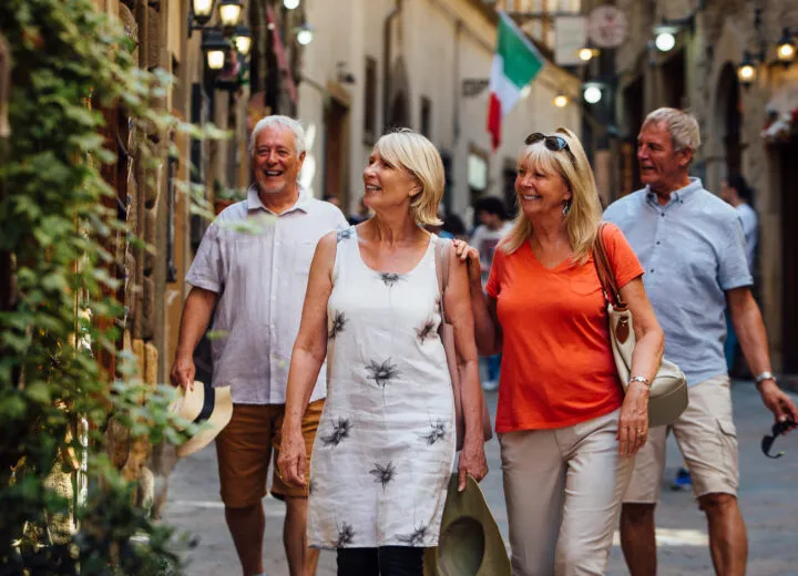 Elegant group travel with friends touring a cultural site, ideal for upscale shared vacation experiences