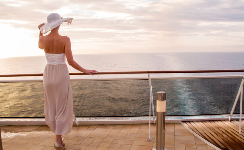 Woman relaxing on the deck of a small ship cruise with Travel Adventures Unlimited, enjoying luxury travel from Walnut Creek and San Francisco
