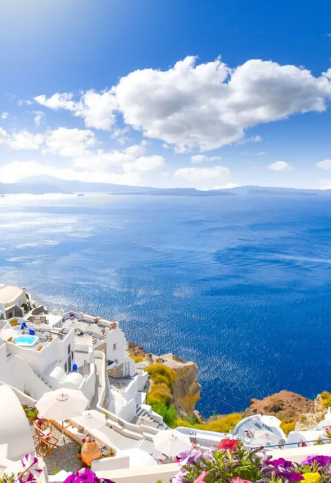 Ocean view from luxury resort suite with open window overlooking turquoise sea and elegant coastal décor