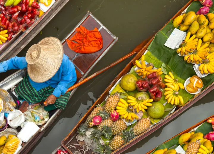 Travelers participating in a hands-on cooking class, preparing traditional dishes during a culinary tour.