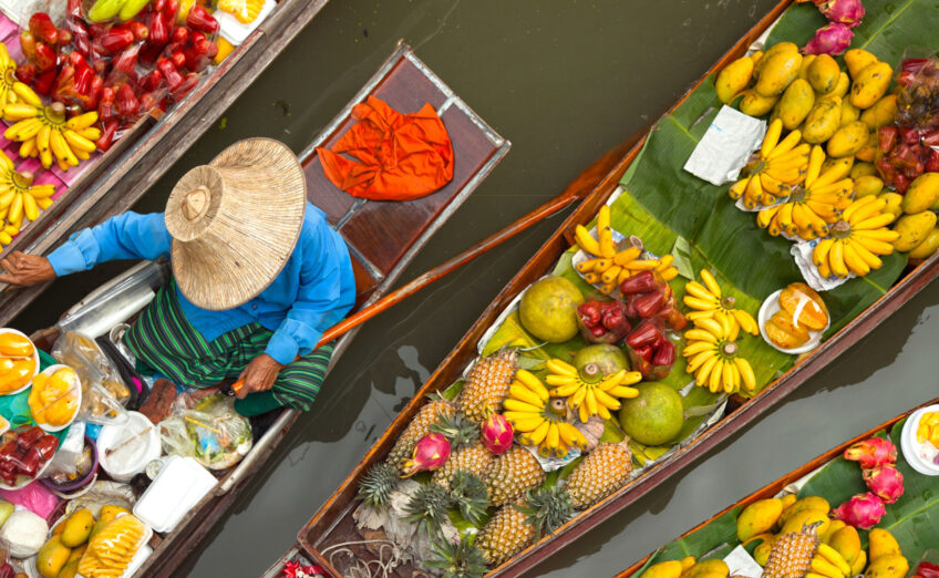 Travelers participating in a hands-on cooking class, preparing traditional dishes during a culinary tour.