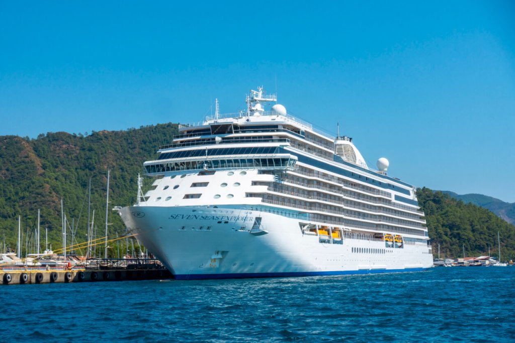Regent Seven Seas Cruises logo in white script on dark background